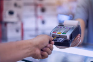 hand inserting credit card to pay